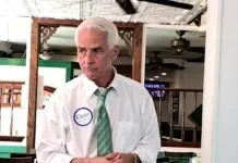 a man in a tie standing in a room