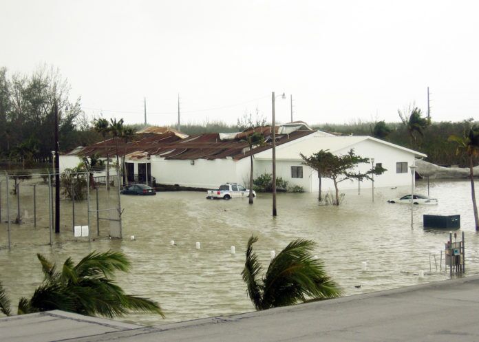 051024-N-7664R-002 a flooded street with houses and palm trees