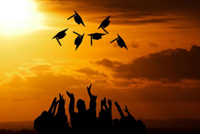 graduation-3649717 a group of graduates throwing their caps in the air
