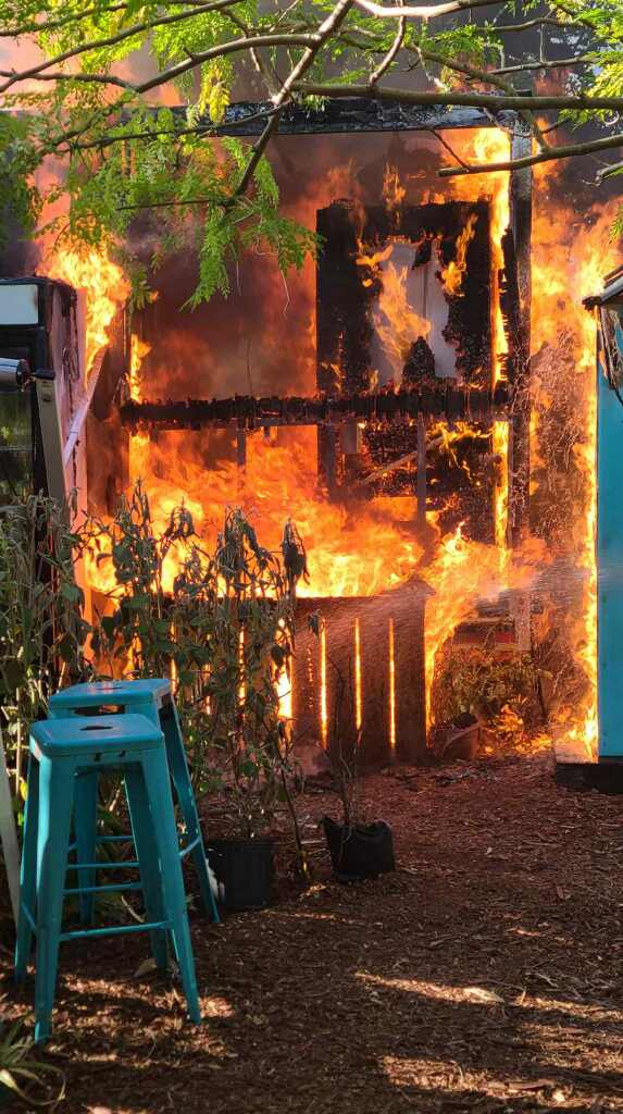 a house on fire with a ladder in front of it