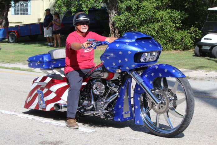 IMG_0291 a man riding a blue motorcycle down a street