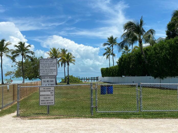 a fenced in area with a sign on it