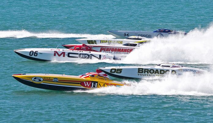 a group of boats racing across a body of water