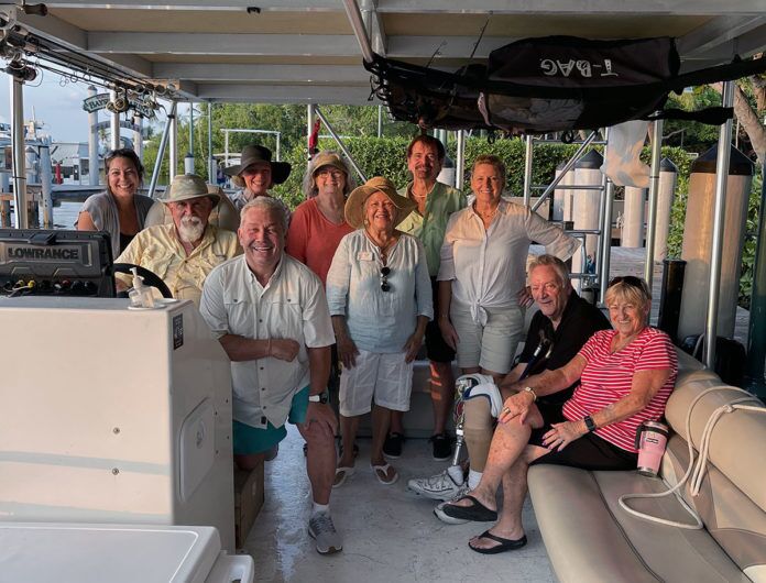 ADA-Charters-1 a group of people on a boat posing for a picture