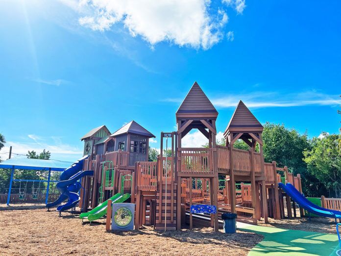 IMG_6780 a playground with a wooden structure and a green slide