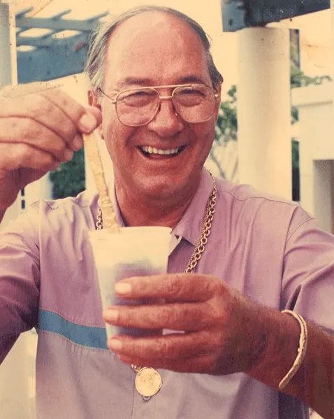 Mel Fisher gold swizzle stick an older man holding a cup of coffee
