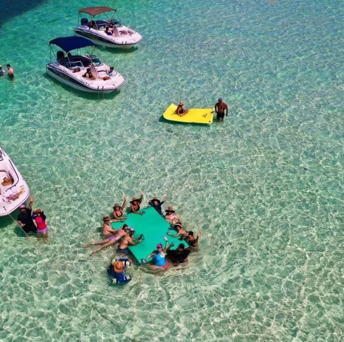 a group of people in the water near boats