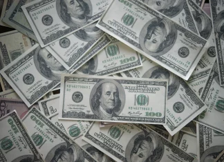a pile of twenty dollar bills sitting on top of each other