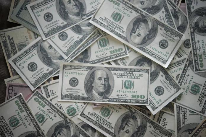 a pile of twenty dollar bills sitting on top of each other
