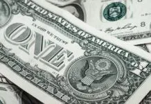 $519-MILLION BUDGET APPROVED BY MONROE COUNTY COMMISSIONERS a pile of twenty dollar bills sitting on top of each other