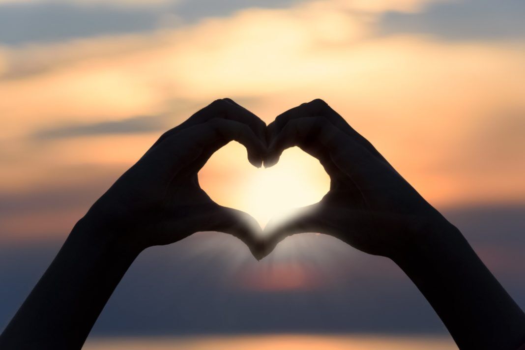 heart-3147976 a person making a heart shape with their hands