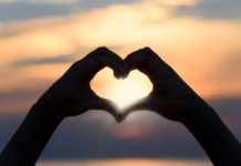 BEHIND THE BLONDE: THE DRINKING DILEMMA a person making a heart shape with their hands