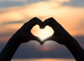 BEHIND THE BLONDE: THE DRINKING DILEMMA a person making a heart shape with their hands
