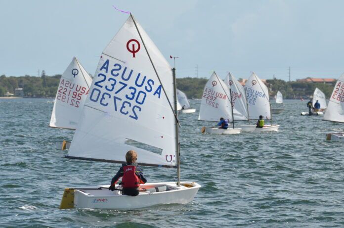a group of sailboats sailing in the water