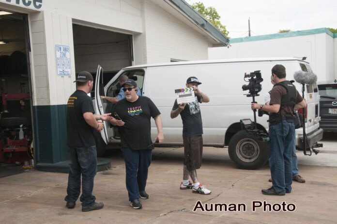 Baumgarten on set Large a group of men standing in front of a white van