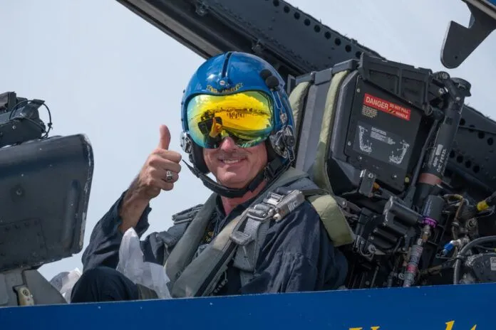 a man sitting in the cockpit of a plane giving a thumbs up