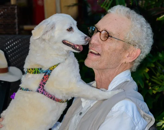 KW Musicians-246 2 Large a man holding a white dog in his arms