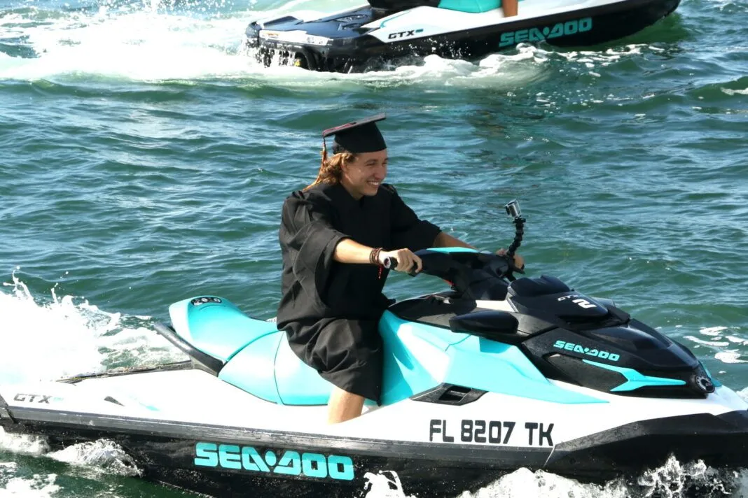 Lucas Tarnowski jet ski a woman riding on the back of a blue and black jet ski
