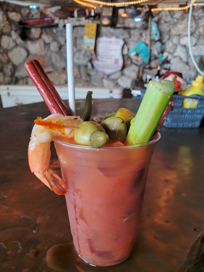 a bloody drink with pickles, celery, and carrots