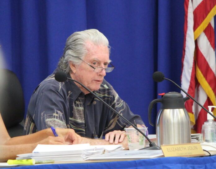 Henry Rosenthal (1) a man sitting at a table with a microphone in front of him