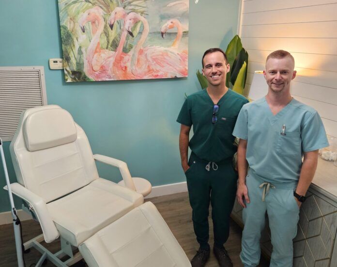 Tommy Iglesias _ Dr Greg Keifer a couple of men standing next to each other in a room