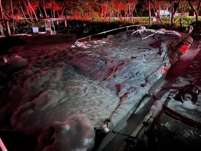 a bench covered in snow in a park at night