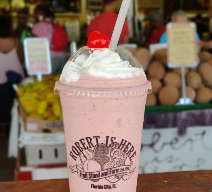 Milkshake a pink drink with whipped cream and a cherry on top