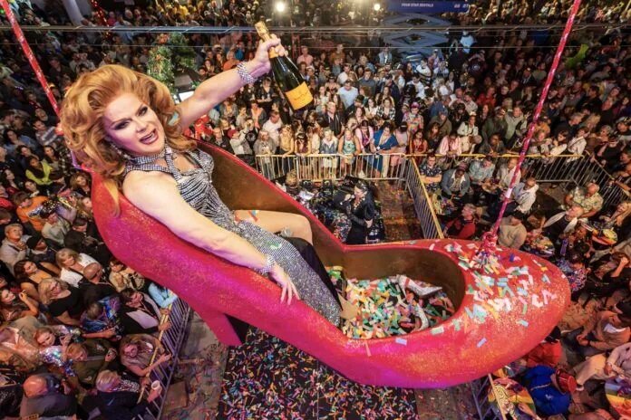 New Year_s Eve Shoe Drop 2023 NWM--22 Large a woman riding a giant pink object in front of a crowd