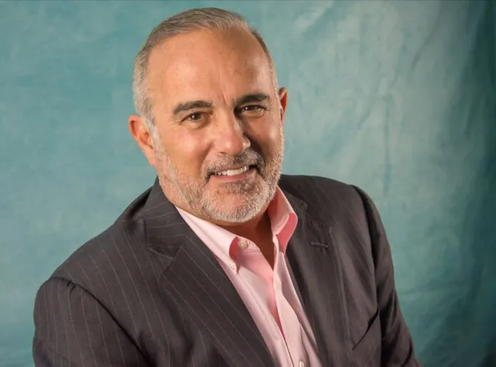 a man wearing a suit and pink shirt