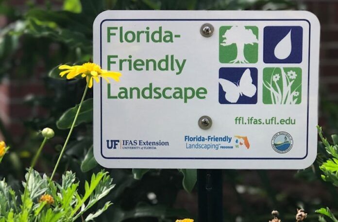 a sign that is in front of some flowers