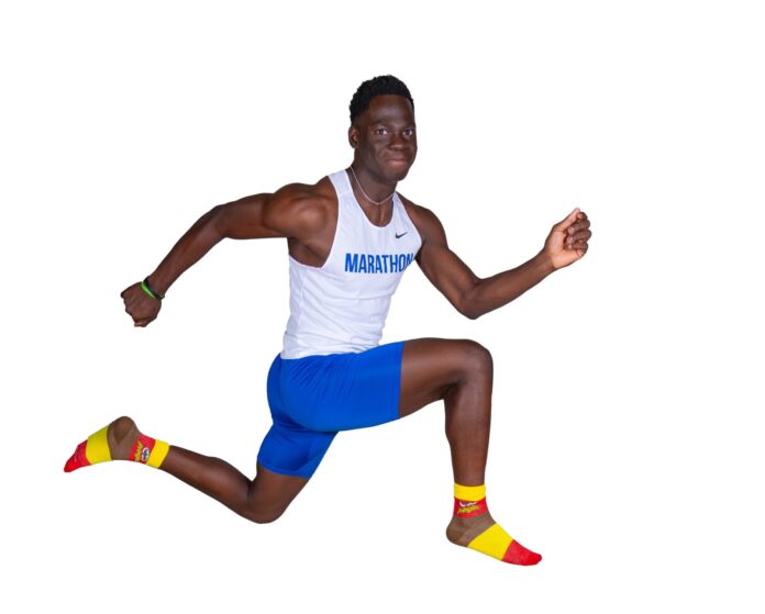 SPP_0134-Edit a man in a white shirt and blue shorts is running
