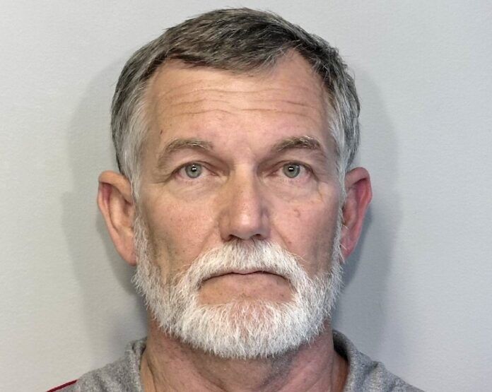 a man with a white beard and a gray shirt