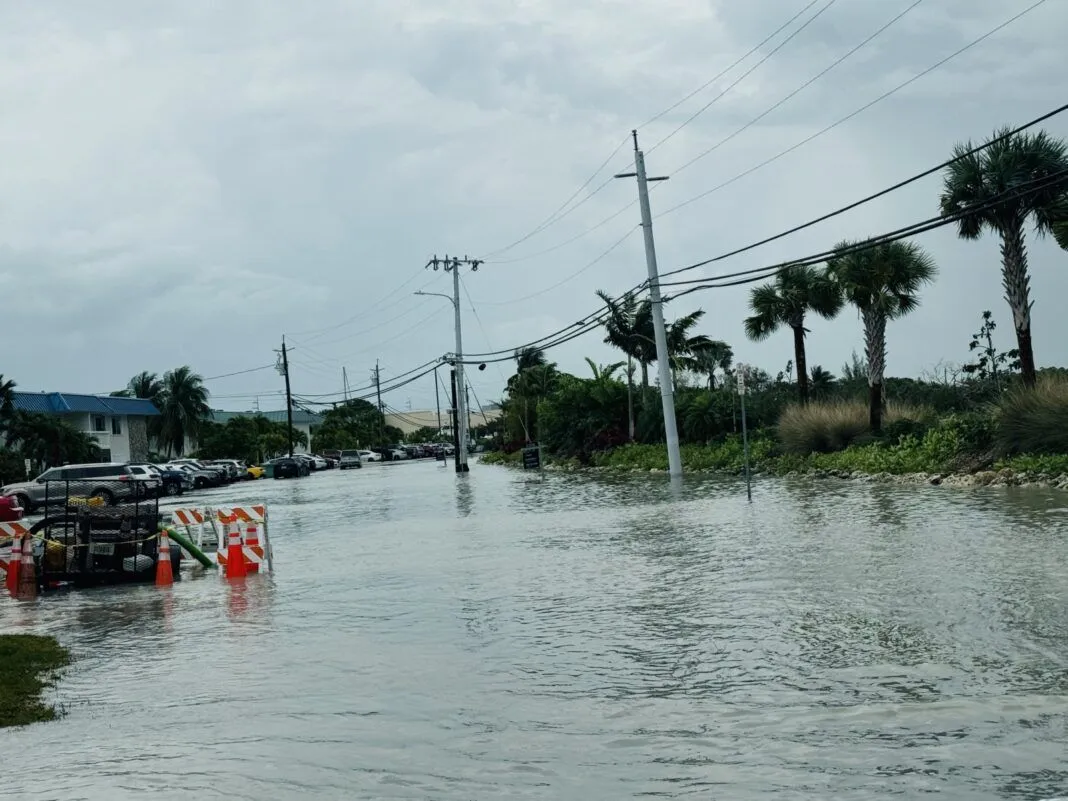 a flooded street with cars parked on the side of it