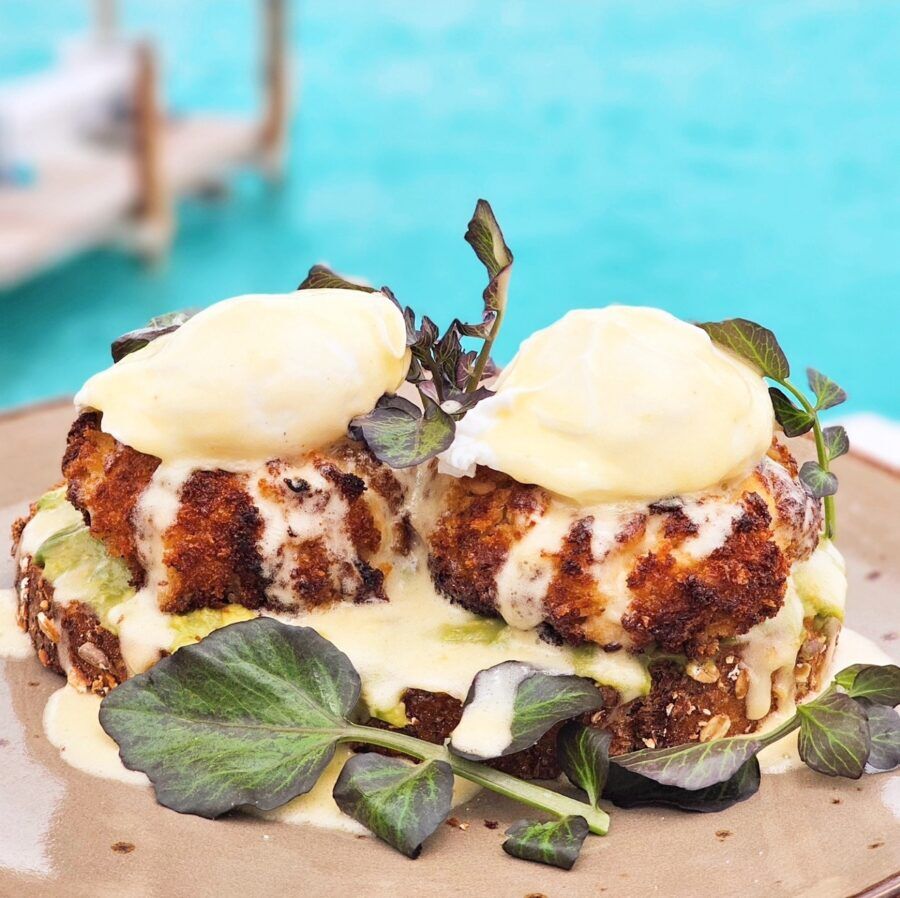 a plate of food on a table next to a pool