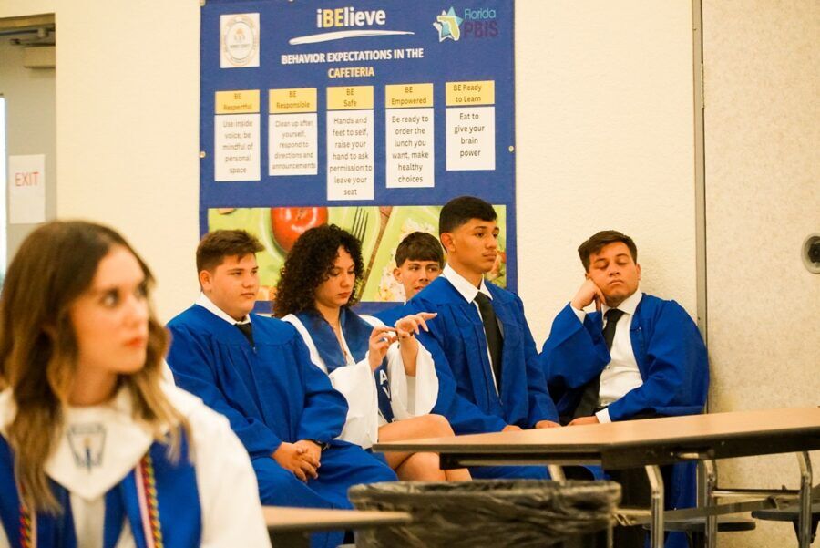 a group of students sitting at desks in a classroom