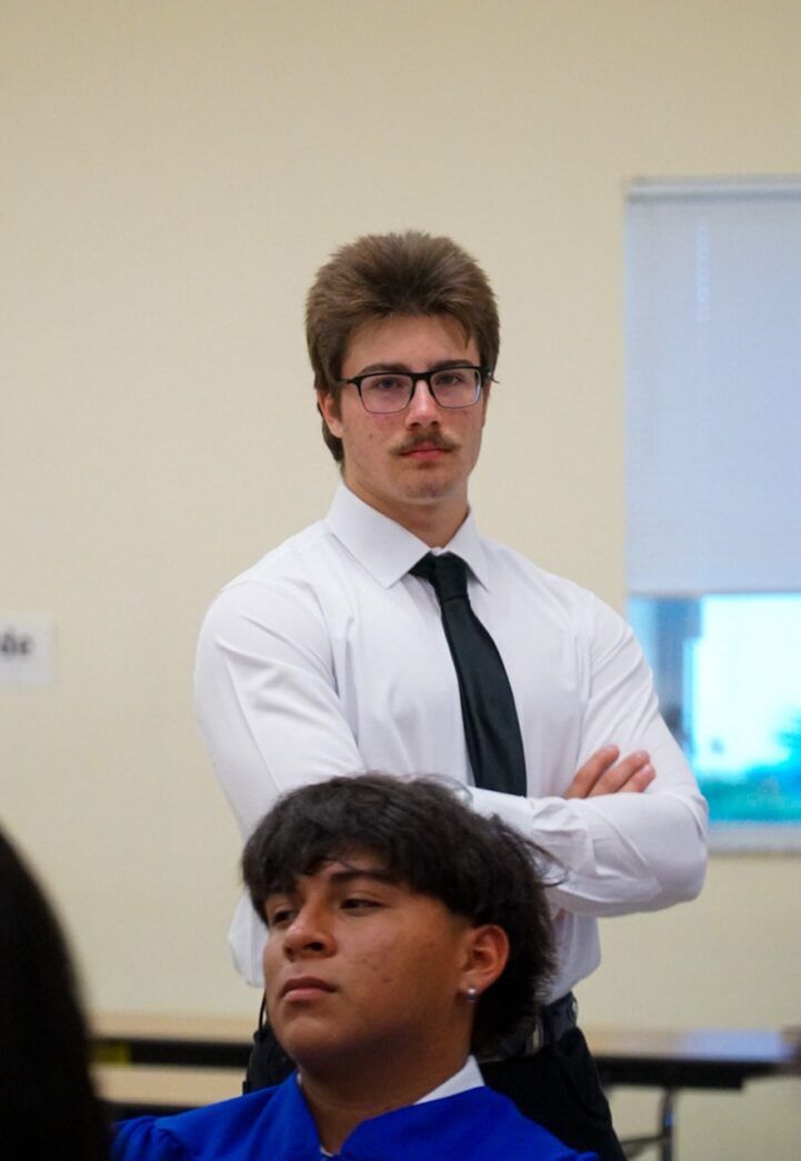 a man in a white shirt and black tie