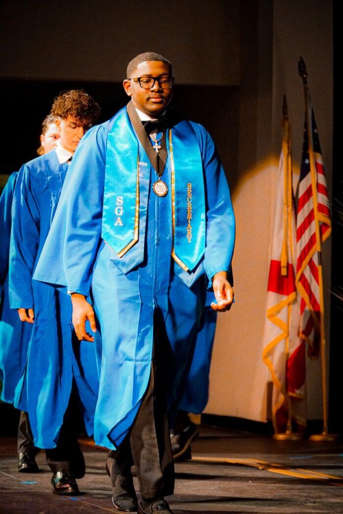 a group of men walking across a stage