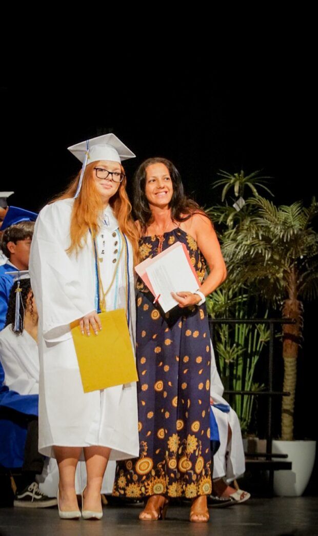 a couple of women standing next to each other on a stage