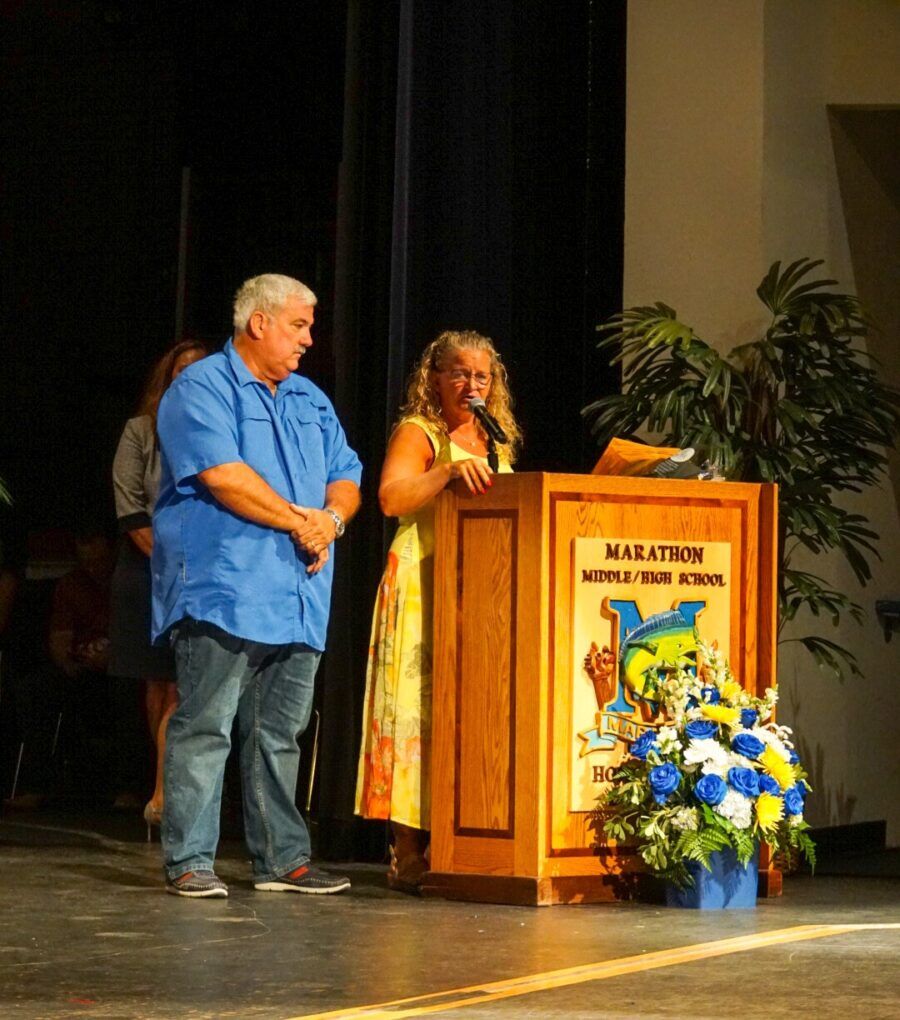 a man and a woman standing at a podium