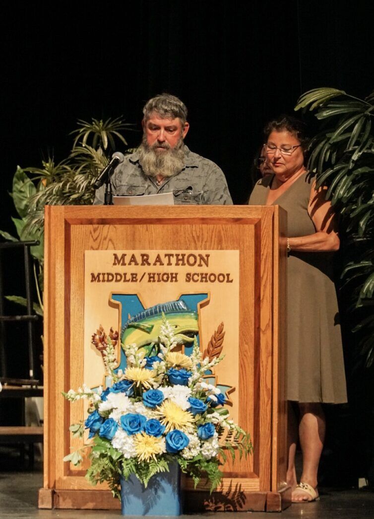 a man and a woman standing at a podium
