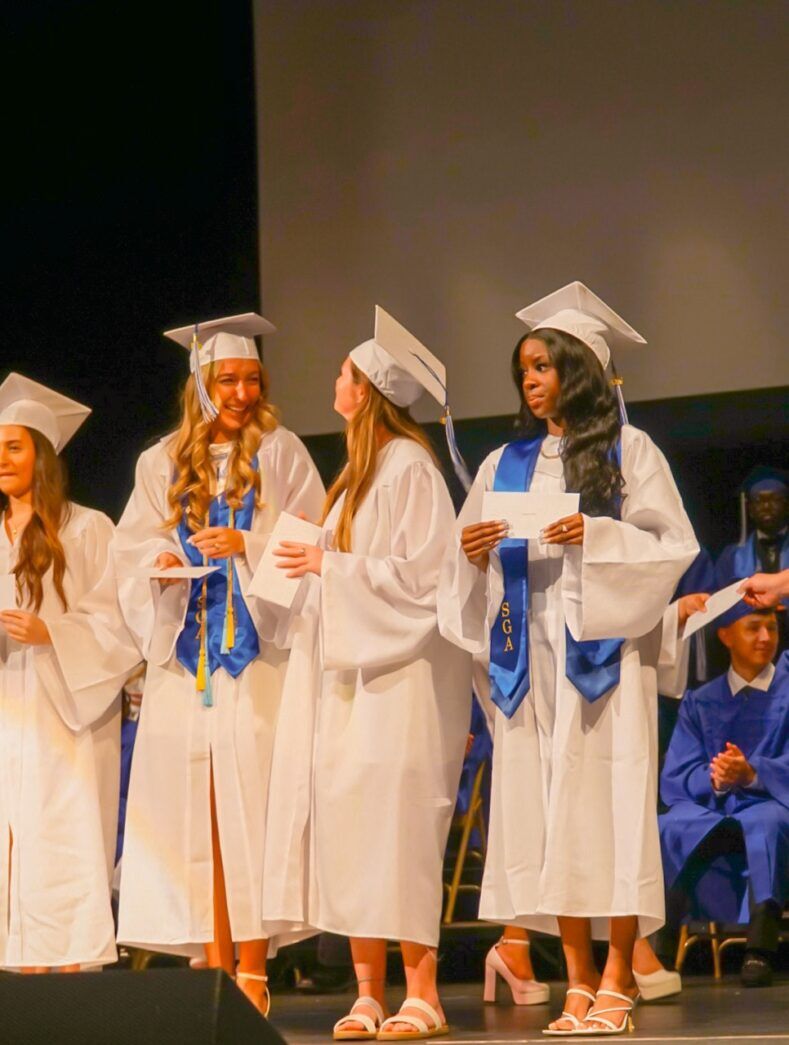 a group of graduates standing on a stage