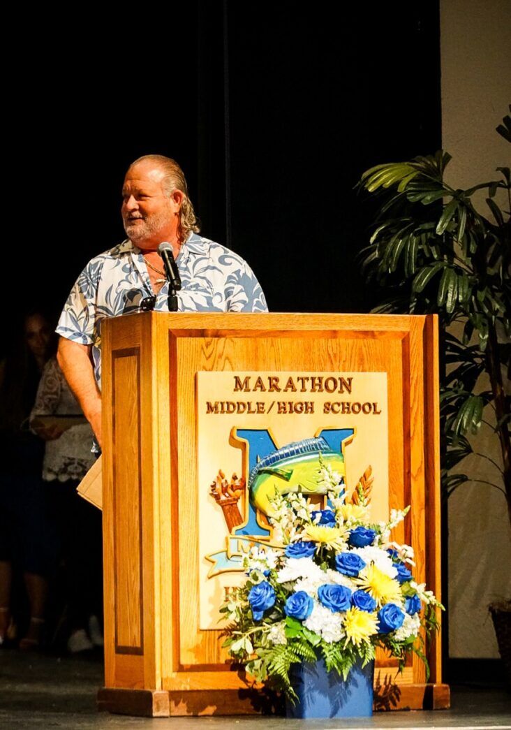 a man standing at a podium with a microphone