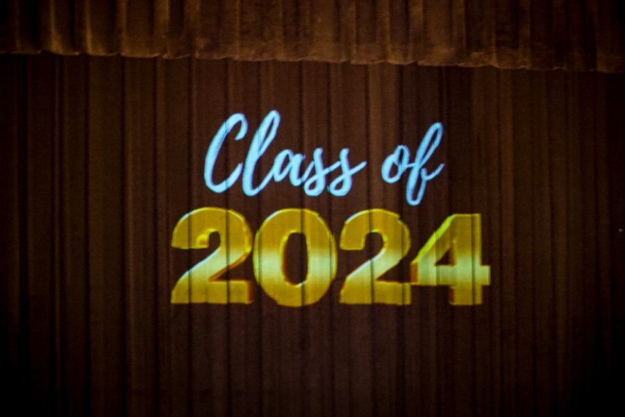 a sign that says class of 2024 on a stage