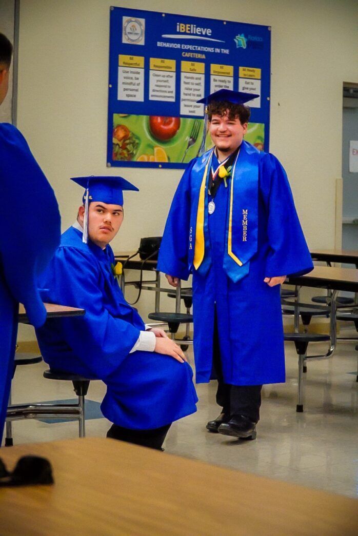 a group of young men in graduation gowns