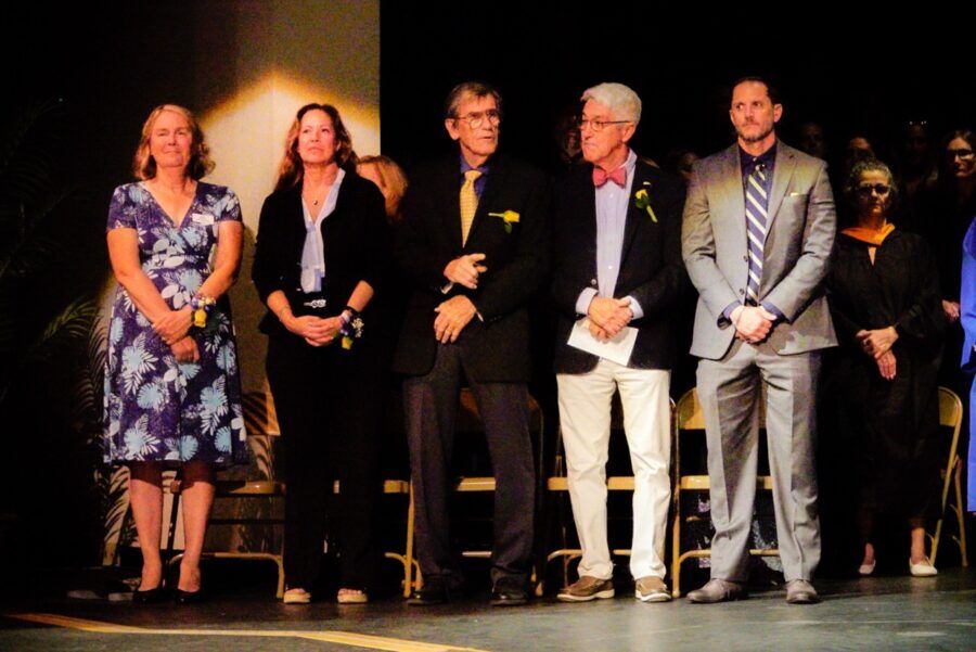 a group of people standing next to each other on a stage