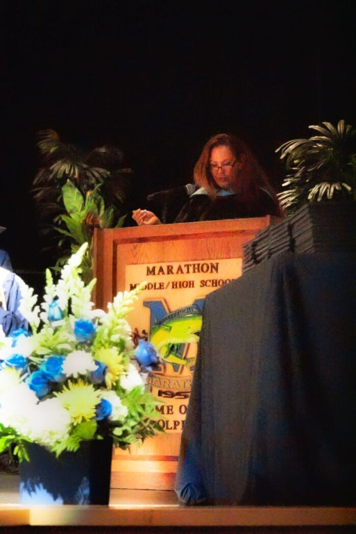 a man standing at a podium in front of a crowd