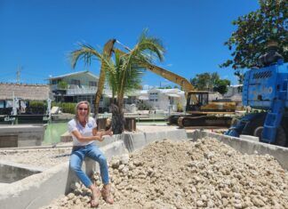 KEY LARGO CANAL RESTORATION RESTORES WATER QUALITY a woman sitting on a pile of dirt