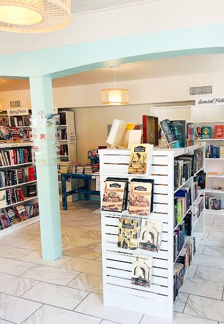 a room filled with lots of books and furniture