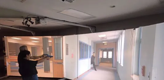 a woman standing in front of a projector screen
