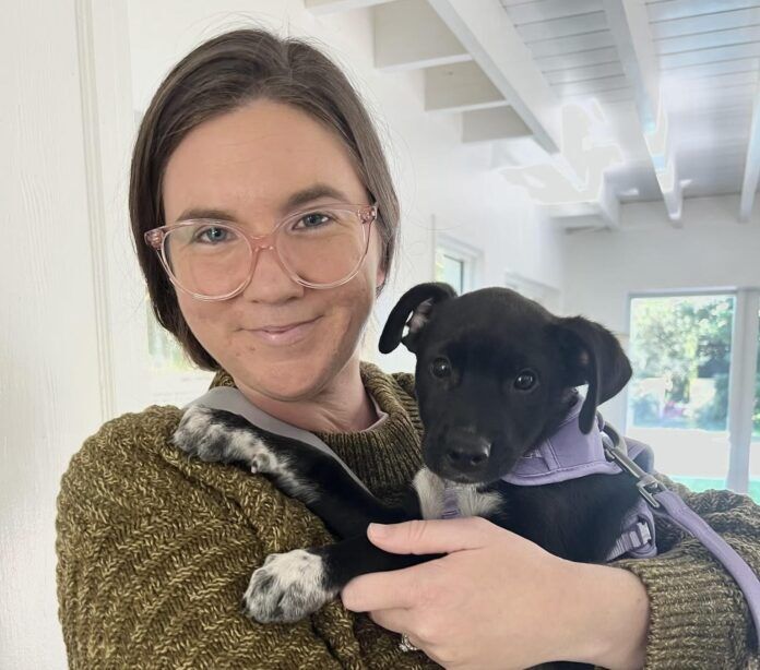 Stacey Nichter a woman holding a small dog in her arms